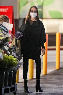 Angelina Jolie wearing black ankle boots.