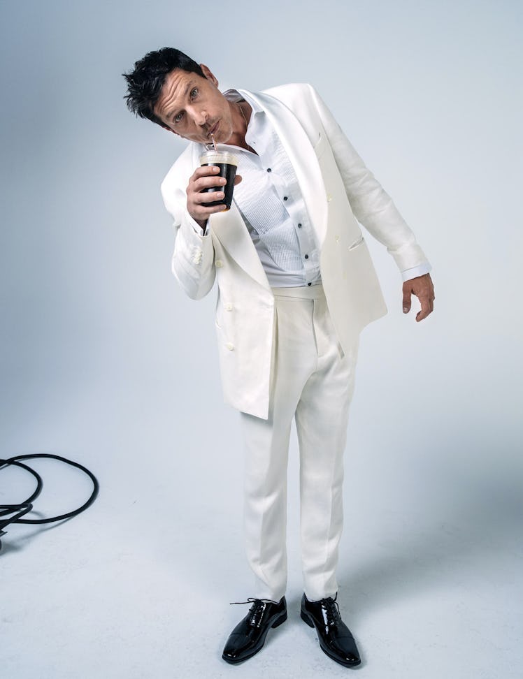 Simon Rex in a white tuxedo and shirt with black shoes in W Magazine's Best Performances