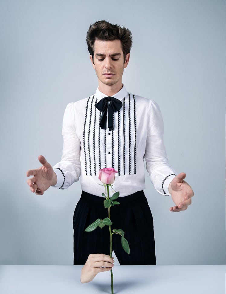 Andrew Garfield in a shirt, pants, and bowtie with a pink rose in front of him in W Magazine's Best ...