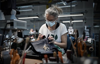 This picture taken on Jan. 6, 2022 shows an employee working on a leather handbag at the leather goo...