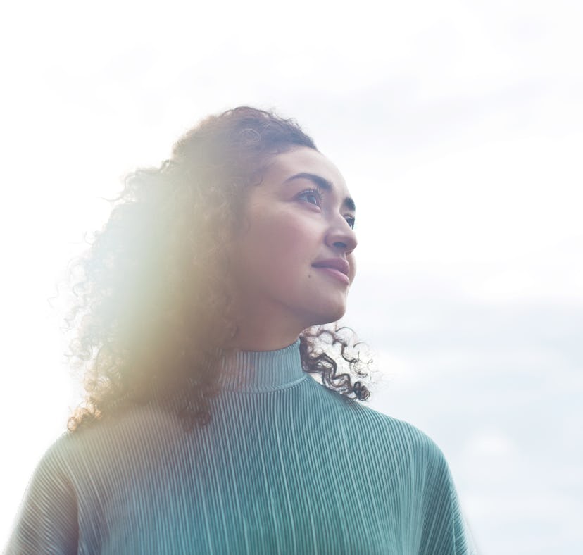 Young woman looking toward the full moon the week of January 17, 2022, which will be the best for he...