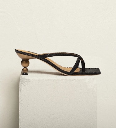 Chelsea Paris' Slash Black Mules. 