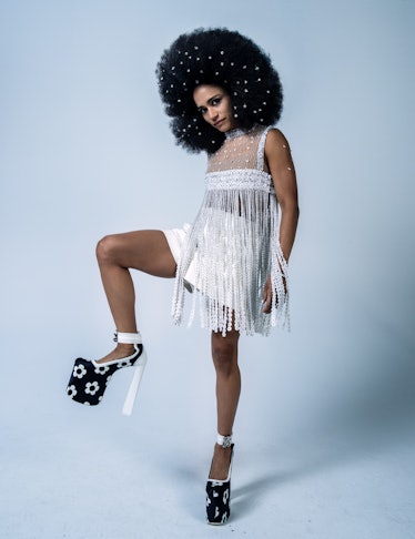 Lauren Ridloff in a white top and shorts with flower pattern platform heels in W Magazine's Best Per...