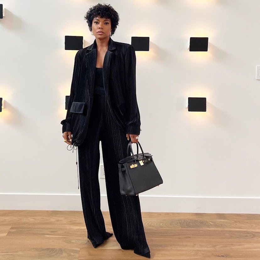 Gabrielle Union in a black suit and top with a black Birkin bag