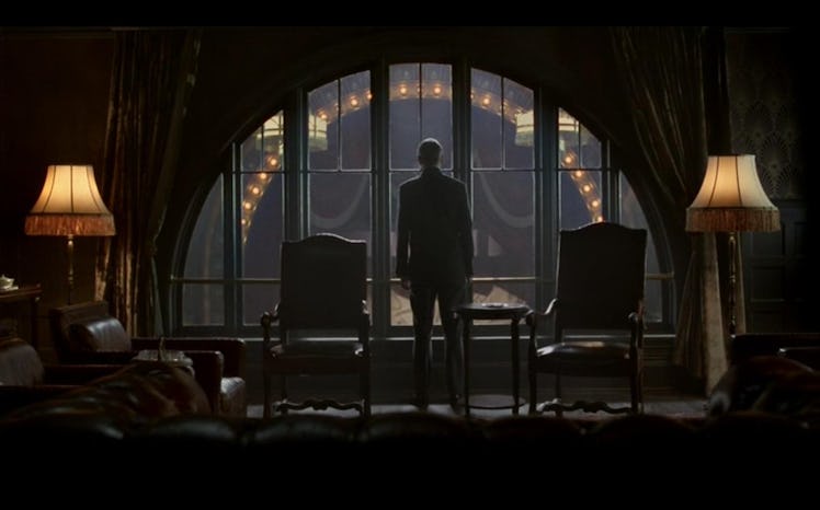 A scene from Tinker Tailor Soldier Spy with a person looking out of a window 