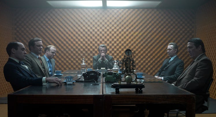 A scene from Tinker Tailor Soldier Spy with six people having a meeting around a table 