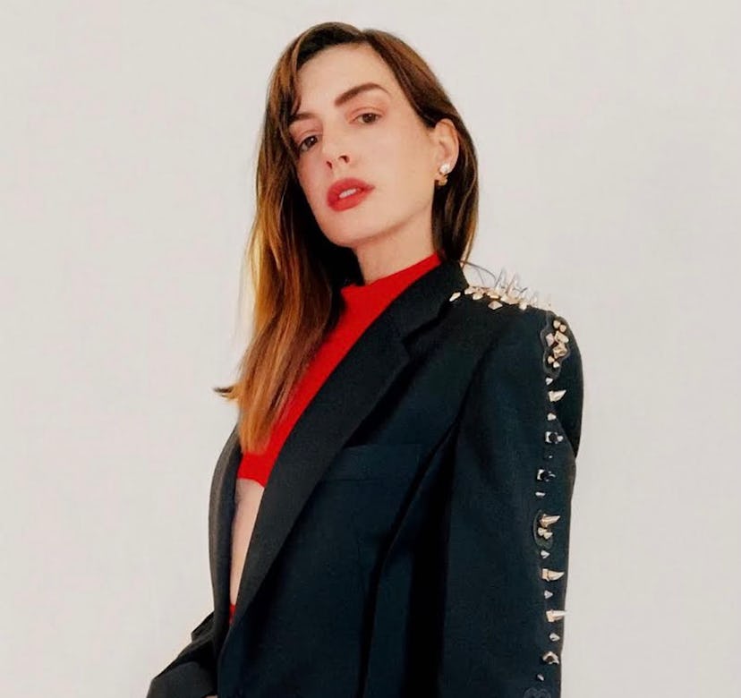 Anne Hathaway wearing a coat for a Givenchy virtual show.