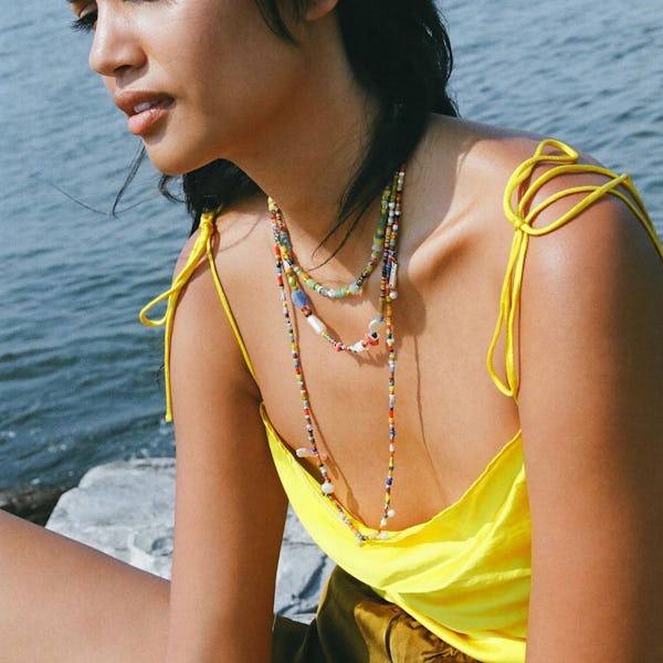 A model wearing layered colorful beaded necklaces by SVNR