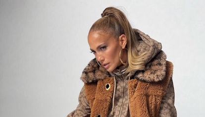 Jennifer Lopez wearing gold hoop earrings. 