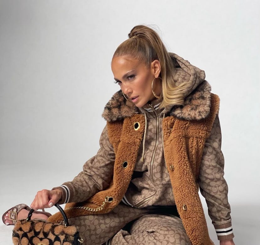 Jennifer Lopez wearing gold hoop earrings.