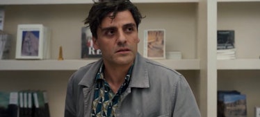 Oscar Isaac in Moon Knight in a grey jacket looking exhausted