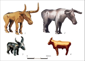 Four gold and silver bull figurines