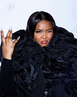 Lizzo with black coat long nails