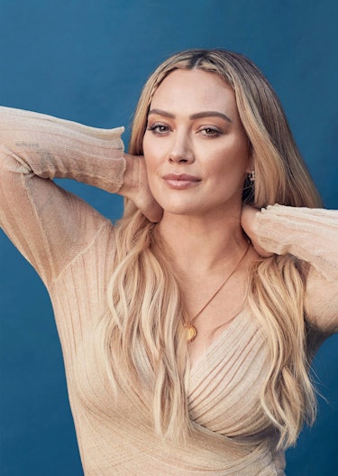 Hillary Duff posing in a beige colored Dior top, Swarovski earrings and a Third Crown necklace