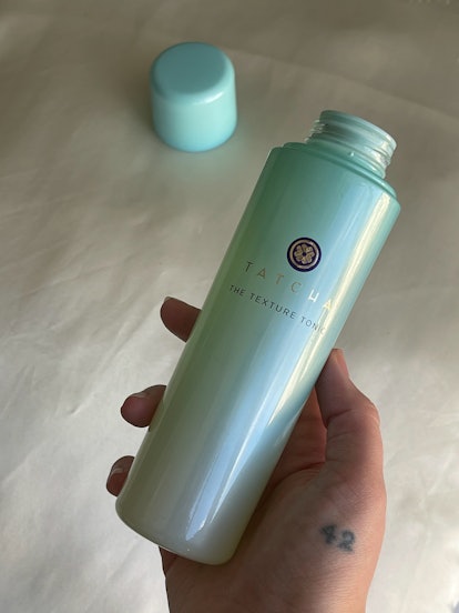 The texture tonic bottle in Isabella's hand