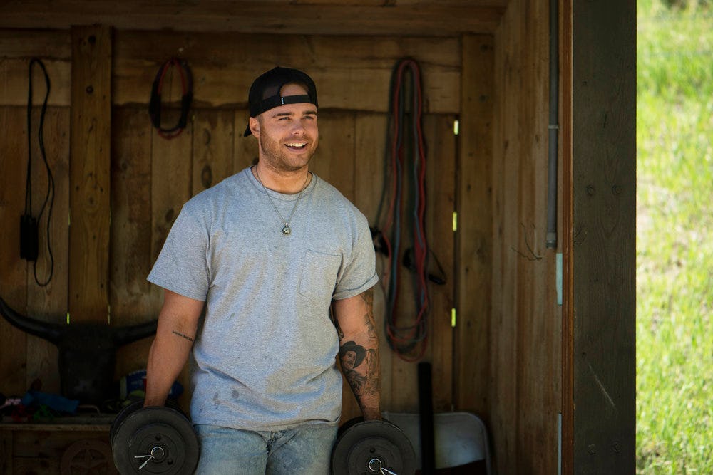 Austin Gunn from &lsquo;Relatively Famous: Ranch Rules&rsquo; working in a barn.