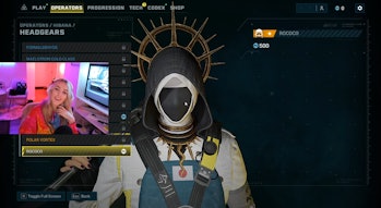 Screenshot from Kate Irwin's Twitch stream showing Hibana's Rococo headgear, which has black fabric ...