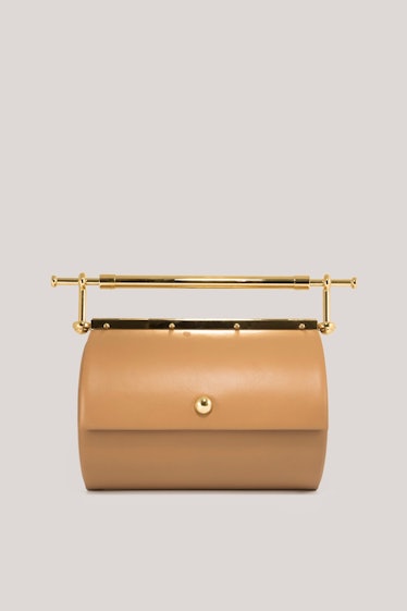 2022 handbag trends unique shapes tan leather clutch with gold handle