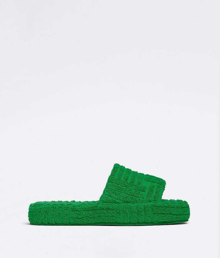 Bottega Veneta's Resort Sponge Slides in grass. 