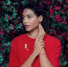 A model wearing red and gold jewelry. 