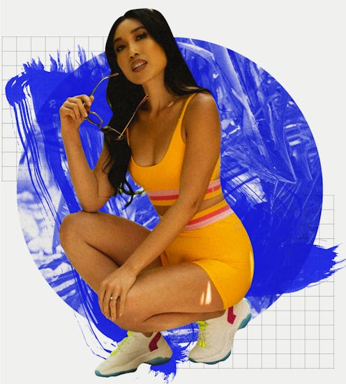 Fitness Influencer Cassey Ho squatting in an orange sports bra an shorts set and white sneakers