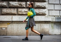 Gala Gonzalez with mini skirt, loafers, and clutch