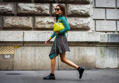 Gala Gonzalez with mini skirt, loafers, and clutch