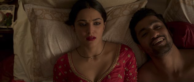 A disappointed Megha lies next to a satisfied looking Paras