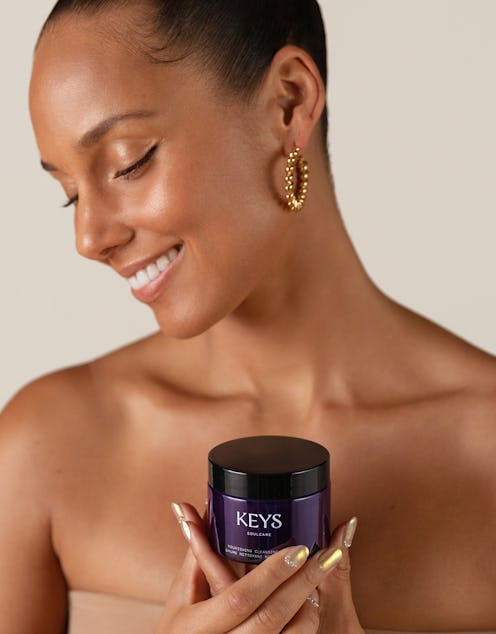 Alicia Keys holding the Nourishing Cleansing Balm from her Keys Soulcare skincare line