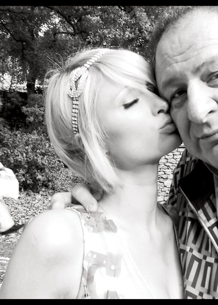 A selfie of Paris Hilton kissing Jean Pigozzi on the cheek in black and white 