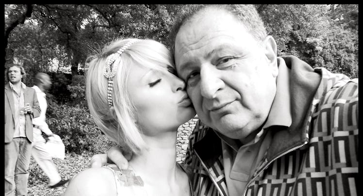 A selfie of Paris Hilton kissing Jean Pigozzi on the cheek in black and white 
