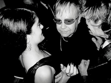  Salma Hayek, Elton John, and Mick Jagger sharing a moment at a party
