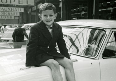 Jean Pigozzi as a child sitting on a car