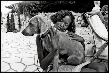 Naomi Campbell cuddling with Pigozzi’s dog Charles.
