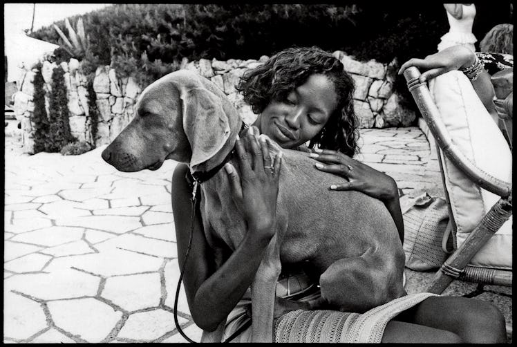 Naomi Campbell cuddling with Pigozzi’s dog Charles.
