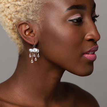 Model wearing cloud pearl earrings with gems