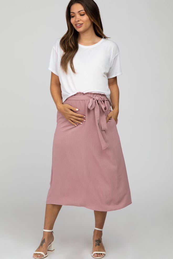 Pregnant woman modeling midi skirt 