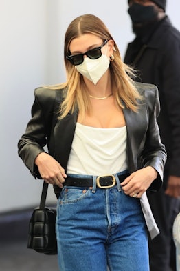 Hailee Bieber wearing a black leather blazer with jeans and a Bottega Veneta bag