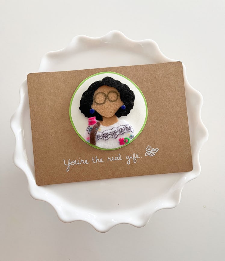 This Mirabel greeting card is part of the 'Encanto' merchandise on Etsy. 