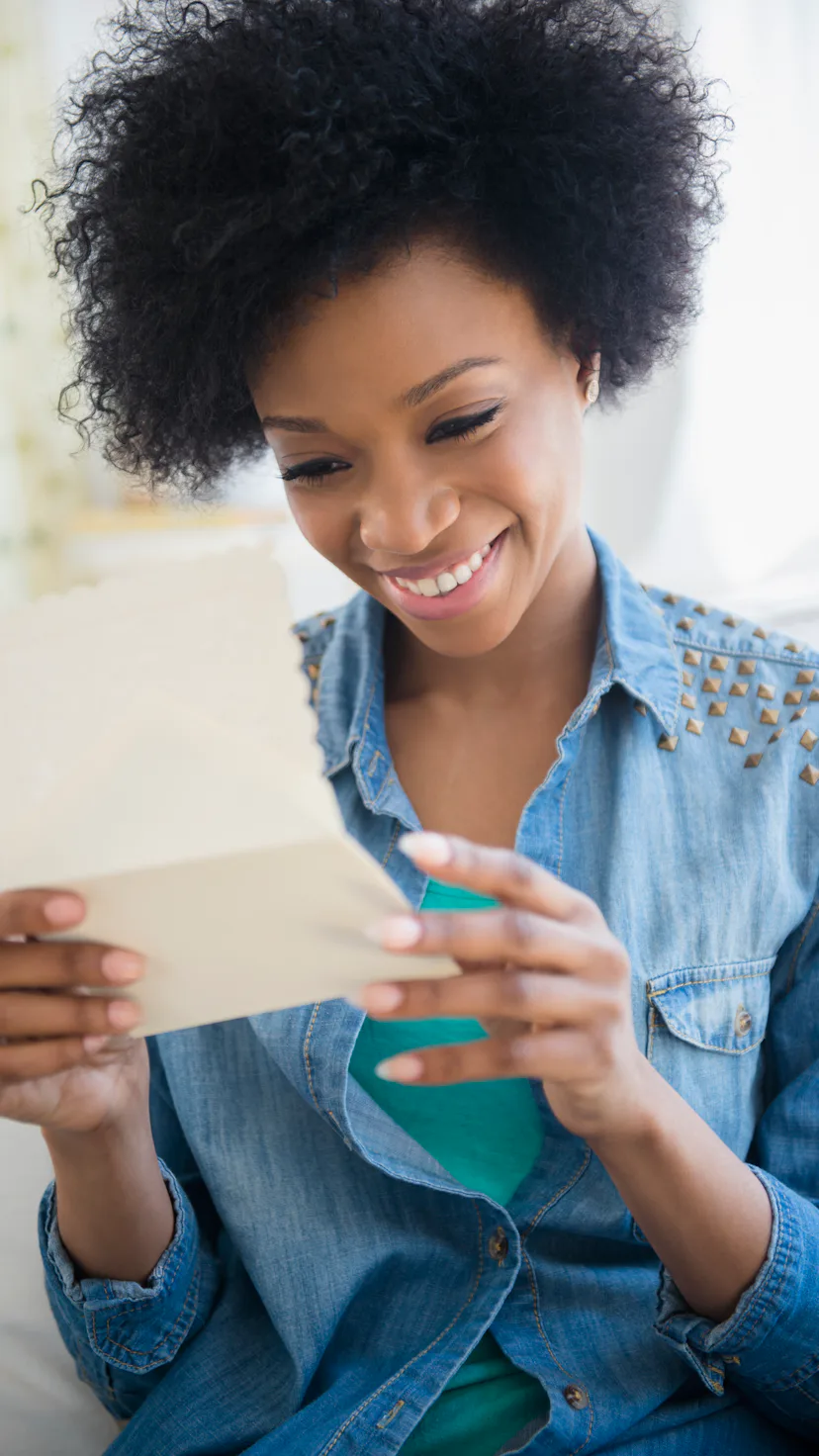 happy woman reading a card
