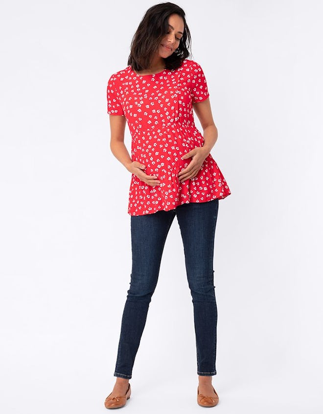 Pregnant woman modeling red peplum top