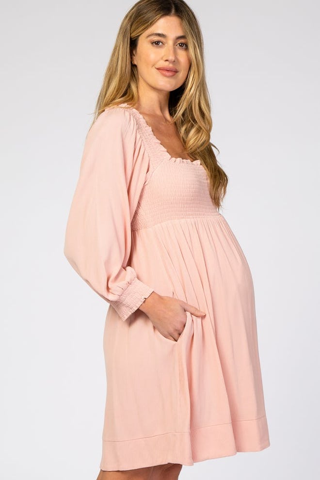 Pregnant woman modeling pink dress