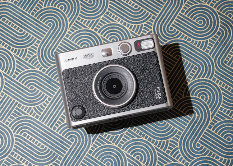 The Instax Mini Evo has a two-tone design inspired by old film cameras.