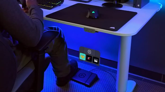 Streamer stepping on left foot pedal of Elgato Stream Deck Foot Pedal.