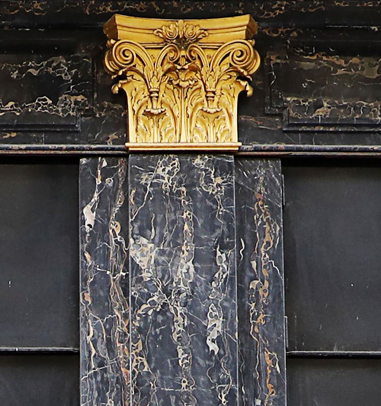 The golden pillar detail on the Cartier store on Place Vendôme, Paris.
