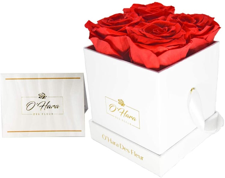 White box with four roses