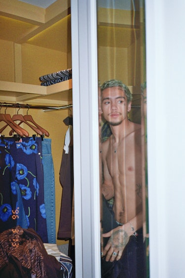 Dominic Fike shirtless trying on clothes. 