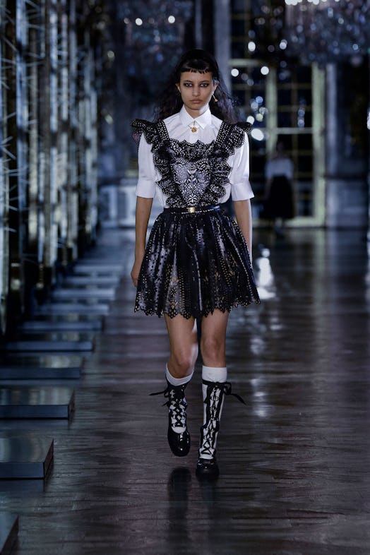 A model walks the Christian Dior runway in a pair of all weather boots.