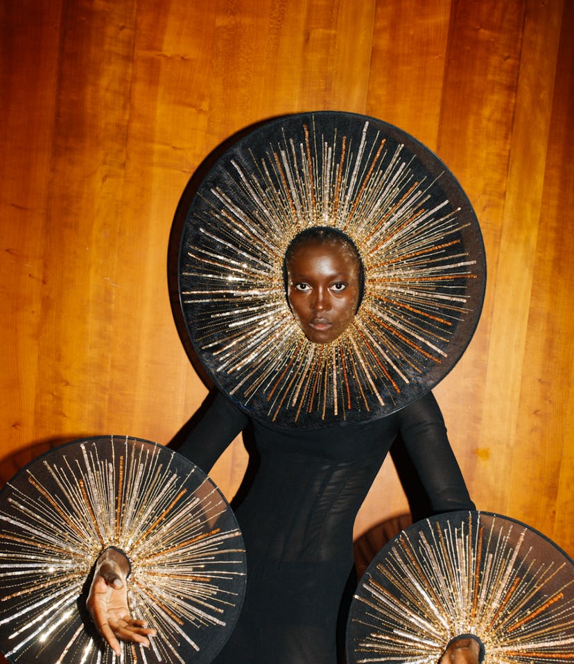 A woman posing in a black Schiaparelli gown