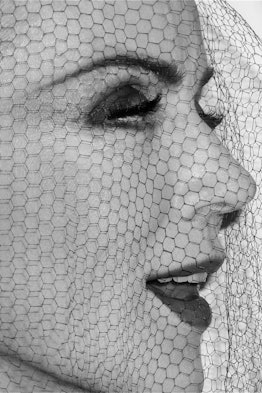 A closeup of Daphne Guinness wearing a veil
